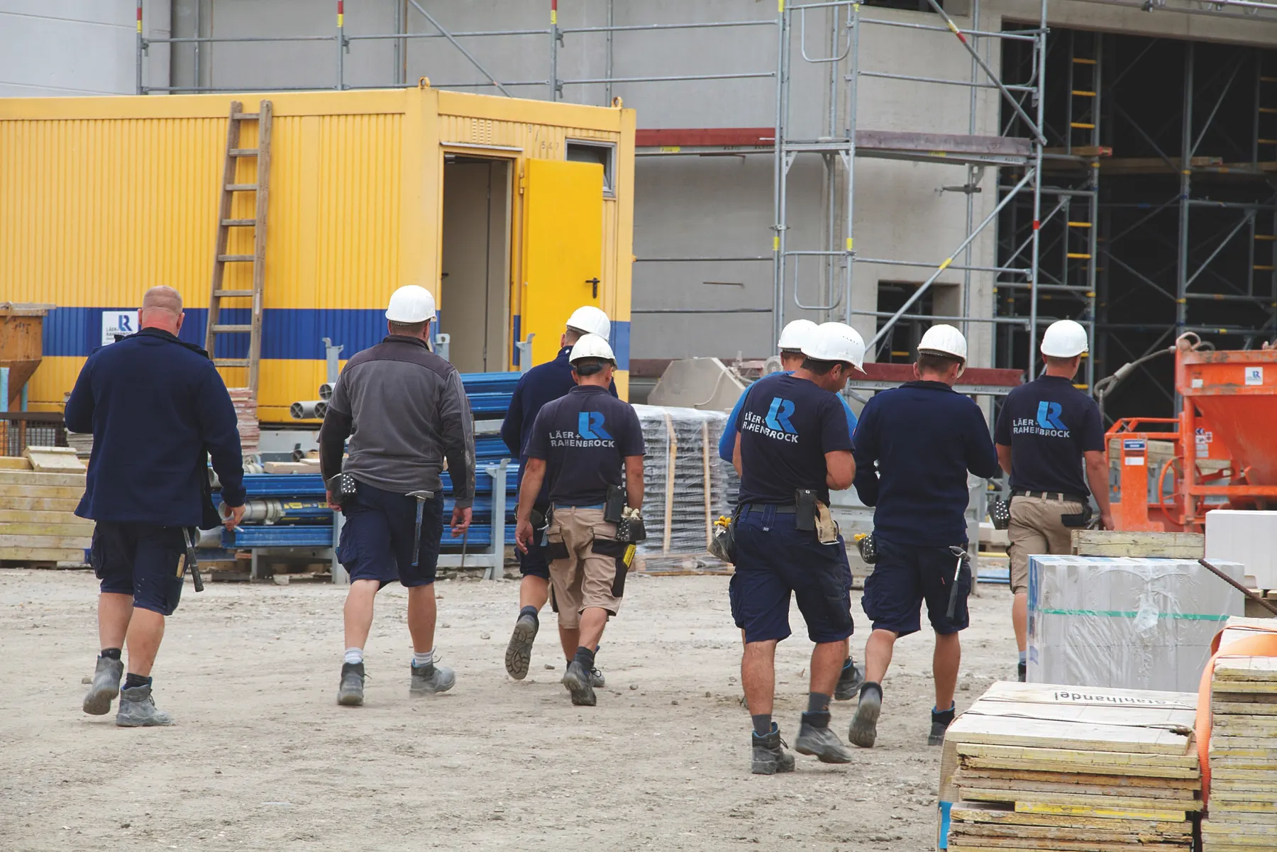 Mitarbeiter von Läer und Rahenbrock gehen gemeinsam über die Baustelle